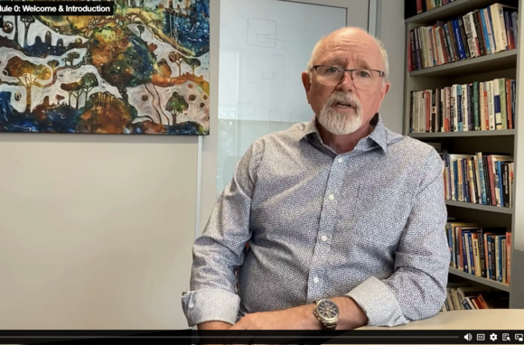 Image of a man speaking in a video